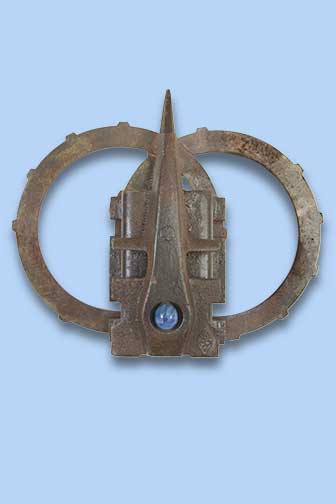 Metal sculpture - central feature has blue stone, backed by two metal circles